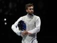 Daniele Garozzo of Italy reacts as compete Tomohiro Shimamura of Japan in the men's Foil team quarterfinal competition at the 2020 Summer Olympics, Sunday, Aug. 1, 2021, in Chiba, Japan. (AP Photo/Hassan Ammar)
