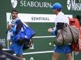 Carlos Alcaraz, of Spain, left, and Jannik Sinner, of Italy, leave the court during a rain delay in their semifinal match at the BNP Paribas Open tennis tournament, Saturday, March 16, 2024, in Indian Wells, Calif. (AP Photo/Mark J. Terrill)