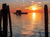 Pellestrina island, Venetian lagoon, Italy - 22 november 2020: Sunset on the Venetian lagoon with the fishermen's house