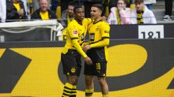 Dortmund's Youssoufa Moukoko, leftt, celebrates with his teammate Watjen Kjell-Arik after he scored his side's first goal during the German Bundesliga soccer match between Borussia Dortmund and Augsburg, in Dortmund, Saturday, May 4, 2024. (AP Photo/Martin Meissner)