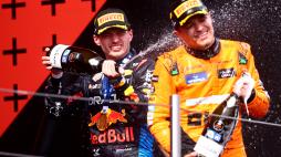 IMOLA, ITALY - MAY 19: Race winner Max Verstappen of the Netherlands and Oracle Red Bull Racing and Second placed Lando Norris of Great Britain and McLaren celebrate on the podium during the F1 Grand Prix of Emilia-Romagna at Autodromo Enzo e Dino Ferrari Circuit on May 19, 2024 in Imola, Italy. (Photo by Lars Baron/Getty Images)