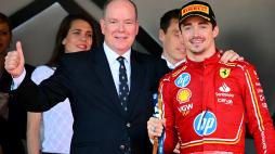 Race winner Ferrari's Monegasque driver Charles Leclerc (R) poses with Prince Albert II of Monaco (L) on the podium after the Formula One Monaco Grand Prix on May 26, 2024 at the Circuit de Monaco. (Photo by NICOLAS TUCAT / AFP)
