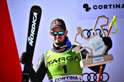 Second-placed Italian Dominik Paris celebrates on the podium after the men's Super-G of the FIS Alpine Ski World Cup in Cortina d'Ampezzo on January 29, 2023. (Photo by Marco BERTORELLO / AFP)