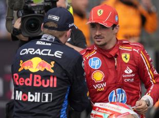 Winner Red Bull driver Max Verstappen of the Netherlands, left, congratulates third placed Ferrari driver Charles Leclerc of Monaco after the Italy's Emilia Romagna Formula One Grand Prix race at the Dino and Enzo Ferrari racetrack in Imola, Italy, Sunday, May 19, 2024. (AP Photo/Antonio Calanni)