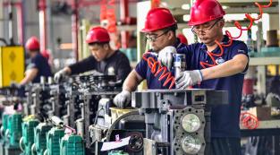 Employees work on an engine assembly line at an engine manufacturing factory in Qingzhou, in China's eastern Shandong province on April 16, 2024. (Photo by AFP) / China OUT