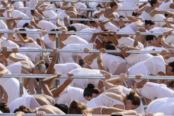 Thousands of young dancers attend the 'white dance' during the event 'One Dance' directed by Italian renowned dancer Roberto Bolle, in front of the Duomo gothic cathedral, in Milan, Italy, Sunday, Sept. 10, 2023. (AP Photo/Luca Bruno)