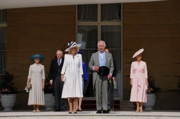 LONDON, ENGLAND - MAY 8: King Charles III and Queen Camilla, stand with the Duke and Duchess of Edinburgh (R) and the Duke and Duchess of Gloucester (L) as they listen to the National Anthem during a Royal Garden Party at Buckingham Palace on May 8, 2024 in London, England.  (Photo by Jordan Pettitt - Pool/Getty Images)