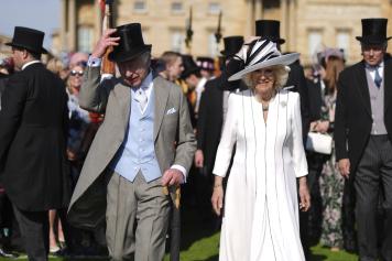 Britain's King Charles III, left, and Queen Camilla attend a Royal Garden Party at Buckingham Palace, London, Wednesday May 8, 2024. (Jordan Pettitt/Pool via AP)