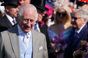 Britain's King Charles III reacts as he meets guests during a Royal Garden Party at Buckingham Palace, central London, on May 8, 2024. (Photo by Jordan Pettitt / POOL / AFP)