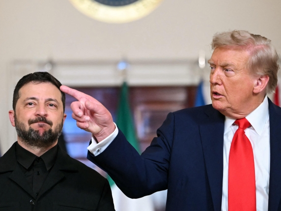 (L/R) Ukrainian President Volodymyr Zelensky and US President Donald Trump stand for a family photo with other European leaders in the Cross Hall of the White House in Washington, DC, on August 18, 2025. European leaders join Ukrainian President V...