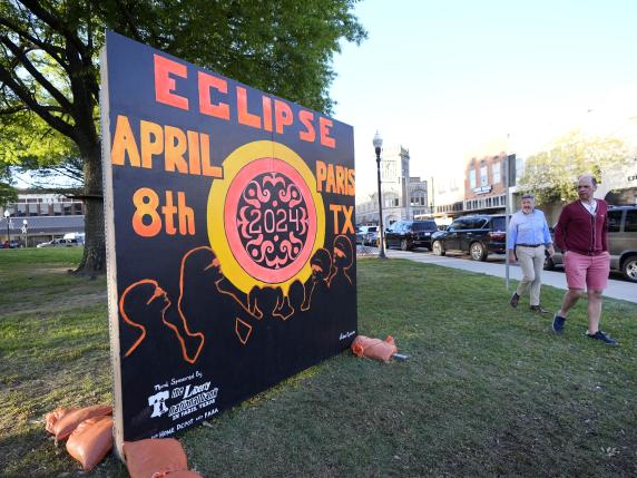 A sign in the town square greets visitors in Paris, Texas, Sunday, April 7, 2024. Paris is one of many small towns along the route where the eclipse can be observd from. (AP Photo/Tony Gutierrez)