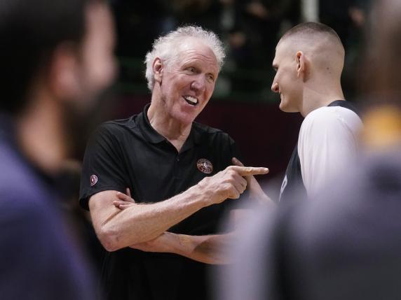 FILE - Basketball Hall of Fame legend Bill Walton, left, jokes with Denver Nuggets center Nikola Jokic during a practice session for the NBA All-Star basketball game in Cleveland, Feb. 19, 2022. Walton, who starred for John Wooden's UCLA Bruins before becoming a Basketball Hall of Famer and one of the biggest stars of basketball broadcasting, died Monday, May 27, 2024, the league announced on behalf of his family. He was 71. (AP Photo/Charles Krupa, File)