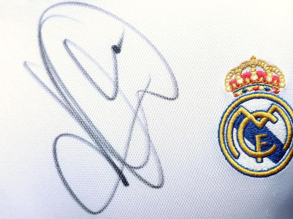This photograph shows an autograph signed by France's forward Kylian Mbappe on a Real Madrid jersey worn by a fan ahead of a training session, as part of the team's preparation for upcoming UEFA Euro 2024 Football Championship, in Clairefontaine-en-Yvelines on May 30, 2024. Having been crowned European champions for the 15th time, Real Madrid have completed another successful season, but the festivities are likely to continue for a long time to come, with the imminent transfer of Kylian MbappE expected to be made official early next week. (Photo by FRANCK FIFE / AFP)