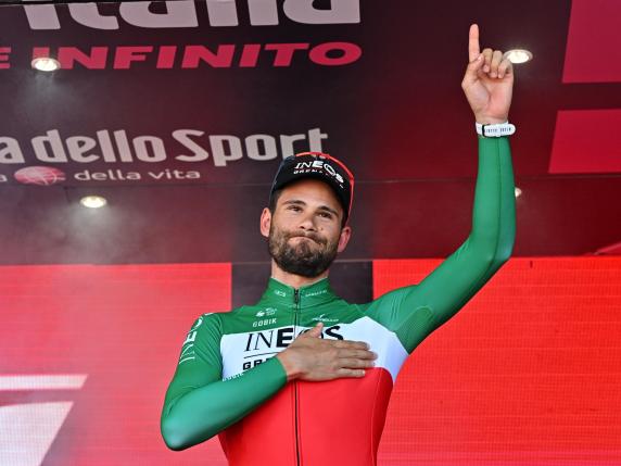 Italian rider Filippo Ganna of Ineos Grenadiers team celebrates on the podium after winning the 14th stage of the 107 Giro d'Italia 2024, an individual time trial (ITT) over 31.2 km from Castiglione delle Stiviere to Desenzano del Garda, Italy, 18 May 2024. ANSA/LUCA ZENNARO