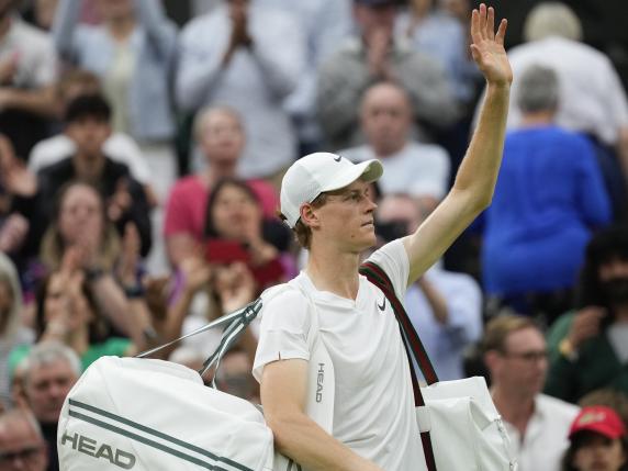 Jannik Sinner of Italy waves as he leaves the court following his quarterfinal loss to Daniil Medvedev of Russia at the Wimbledon tennis championships in London, Tuesday, July 9, 2024. (AP Photo/Alberto Pezzali)