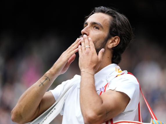 Lorenzo Musetti of Italy blows a kiss to the crowd as he leaves Centre Court after his defeat by Novak Djokovic of Serbia in their semifinal match at the Wimbledon tennis championships in London, Friday, July 12, 2024. (AP Photo/Mosa'ab Elshamy)
