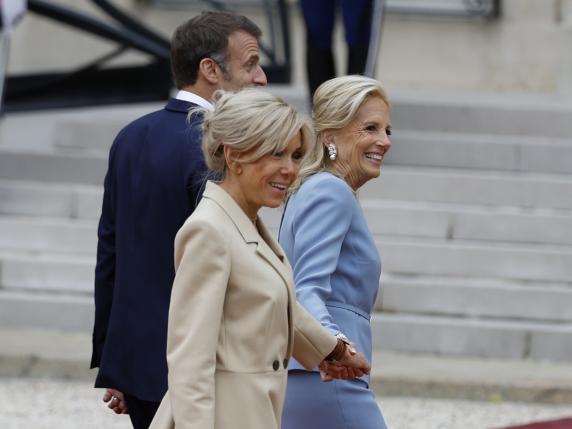French President Emmanuel Macron and his wife Brigitte Macron, left, with First lady Jill Biden walk to at the Elysee Palace ahead of an opening ceremony in which 7,000 Olympic athletes are due to sail down the Seine past iconic Parisian monuments, at the 2024 Summer Olympics, Friday, July 26, 2024, in Paris, France. (AP Photo/Aurelien Morissard)