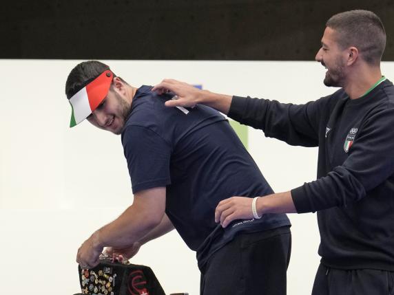 Italy's Paolo Monna, right, congratulates the fellow countryman Frederico Nilo Maldini for finishing second in the 10m air pistol men's final at the 2024 Summer Olympics, Sunday, July 28, 2024, in Chateauroux, France. (AP Photo/Manish Swarup) Associated Press / LaPresse Only italy and Spain