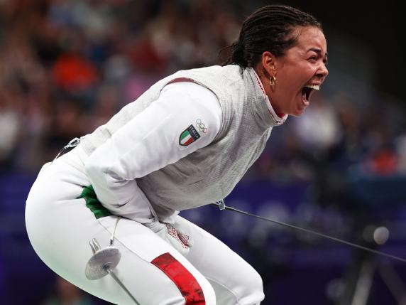 Italy's Alice Volpi reacts as she competes against Germany's Anne Sauer in the women's foil individual quarter-final bout during the Paris 2024 Olympic Games at the Grand Palais in Paris, on July 28, 2024. (Photo by Franck FIFE / AFP)