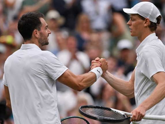 Italy's Jannik Sinner shakes hands with Spain's Pedro Martinez after winning their men's singles third round tennis match on the sixth day of the 2025 Wimbledon Championships at The All England Lawn Tennis and Croquet Club in Wimbledon, southwest London, on July 5, 2025. (Photo by Glyn KIRK / AFP) / RESTRICTED TO EDITORIAL USE