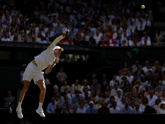 LONDON, ENGLAND - JULY 13: Jannik Sinner of Italy serves against Carlos Alcaraz of Spain during the Gentleman's Singles Final on day fourteen of The Championships Wimbledon 2025 at All England Lawn Tennis and Croquet Club on July 13, 2025 in London, England. (Photo by Julian Finney/Getty Images)