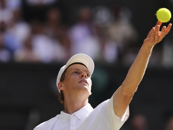 Jannik Sinner of Italy serves to Carlos Alcaraz of Spain during the men's singles final match at the Wimbledon Tennis Championships in London, Sunday, July 13, 2025.(AP Photo/Kirsty Wigglesworth)