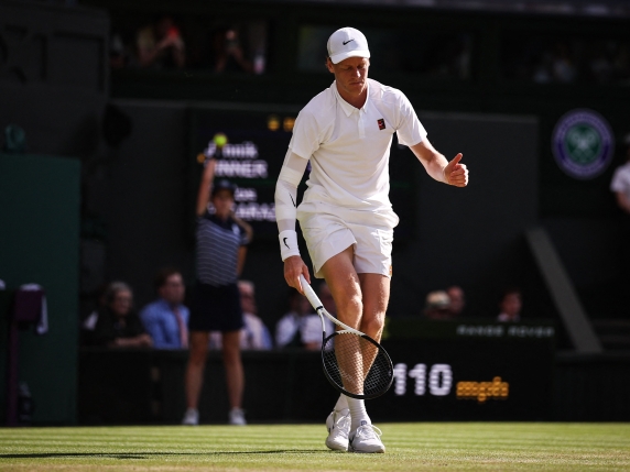 Italy's Jannik Sinner reacts after falling as he plays against Spain's Carlos Alcaraz during their men's singles final tennis match on the fourteenth day of the 2025 Wimbledon Championships at The All England Lawn Tennis and Croquet Club in Wimbledon, southwest London, on July 13, 2025. (Photo by HENRY NICHOLLS / AFP) / RESTRICTED TO EDITORIAL USE
