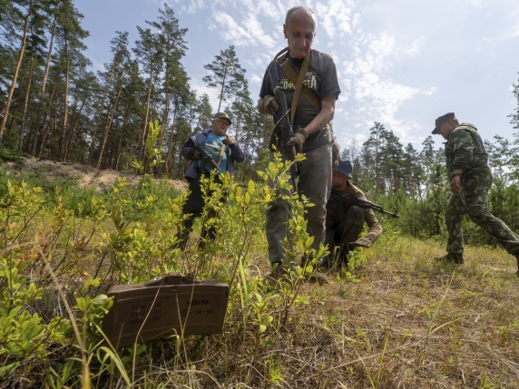 Civilians practice military skills on a training ground in Kharkiv, Ukraine, Saturday, July 12, 2025. (AP Photo/Andrii Marienko)