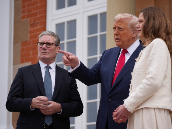 US President Donald Trump (C) and Britain's Prime Minister Keir Starmer (L) speak with the media before a meeting at the Trump Turnberry Golf Courses, in Turnberry south west Scotland on July 28, 2025 flanked by Victoria Starmer (R). (Photo by Chr...