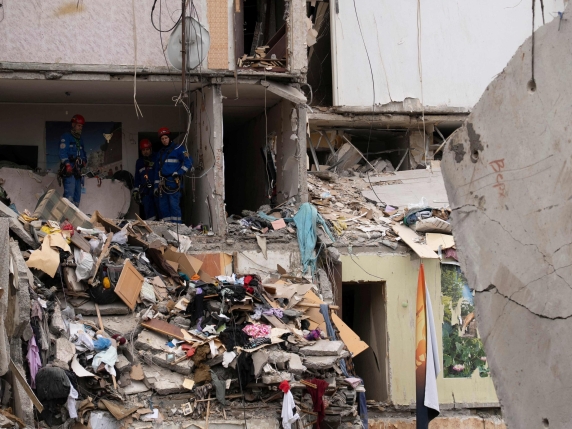 Ukrainian rescuers work among the rubble inside of a destroyed residential building at the site of an air attack in Kyiv on July 31, 2025, amid the Russian invasion of Ukraine. Ukrainian president on July 31, 2025, urged his allies to bring about...