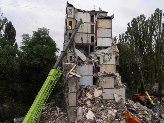 Ukrainian rescuers work among the rubble inside of a destroyed residential building at the site of an air attack in Kyiv on July 31, 2025, amid the Russian invasion of Ukraine. Ukrainian president on July 31, 2025, urged his allies to bring about...