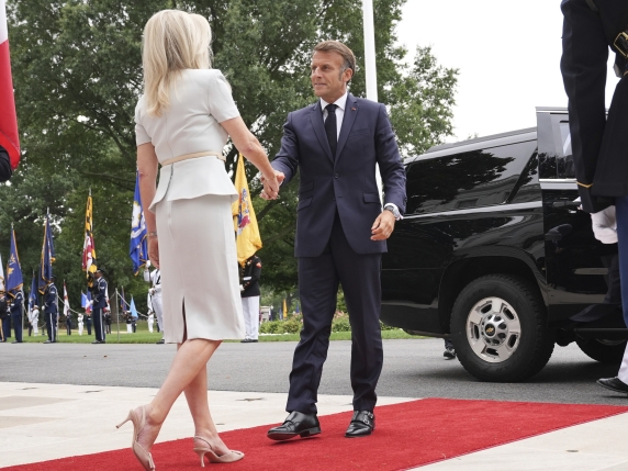 Monica Crowley, White House chief of protocol, left, greets France's President Emmanuel Macron upon arriving to meet with President Donald Trump and Ukraine's President Volodymyr Zelenskyy, Monday, Aug. 18, 2025, at the South Portico of the White...