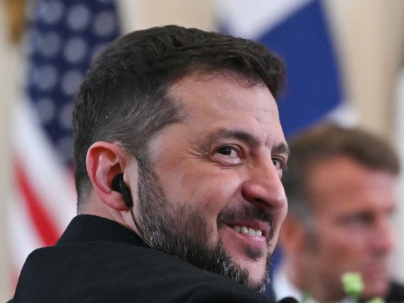 Ukrainian President Volodymyr Zelensky (L) and French President Emmanuel Macron participate in a meeting with European leaders in the East Room of the White House in Washington, DC, on August 18, 2025. European leaders join Ukrainian President Vol...