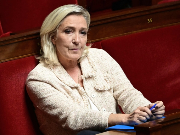 President of Rassemblement National parliamentary group Marine Le Pen listens to speeches following prime Minister's general policy statement during the parliamentary extraordinary session prior to a confidence vote over the government's austerity...