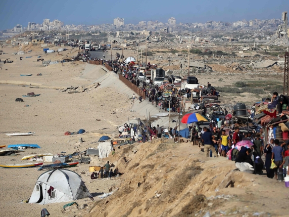 Displaced Palestinians move with their belongings southwards on a road in the Nuseirat refugee camp area in the central Gaza Strip following renewed Israeli evacuation orders for Gaza City on September 16, 2025. Israel launched its long-anticipate...