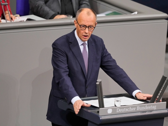 German Chancellor Friedrich Merz addresses the German parliament during a debate at the Reichstag in Berlin, Germany, Thursday, Oct. 16, 2025. (AP Photo/Markus Schreiber)
