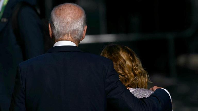 TOPSHOT - US President Joe Biden (L) and Italy's Prime Minister Giorgia Meloni leave after the group photo at the end of the first session of the G20 Leaders' Meeting in Rio de Janeiro, Brazil, on November 18, 2024. (Photo by Mauro PIMENTEL / AFP)