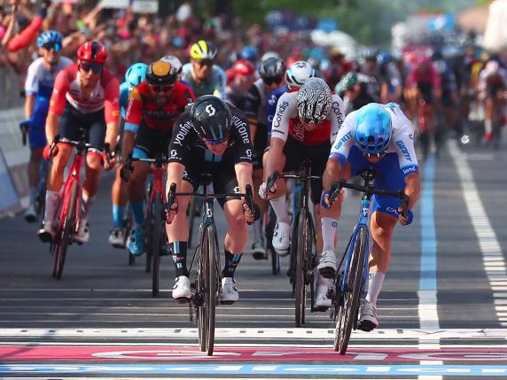 Team DSM's Italian rider Alberto Dainese (C) sprints across the finish line to win the seventeenth stage ahead of third-placed Team Jayco AlUla's Australian rider Michael Matthews (R) during the Giro d'Italia 2023 cycling race, 197 km between Pergine Valsugana and Caorle, near Venice on May 24, 2023. (Photo by Luca Bettini / AFP)