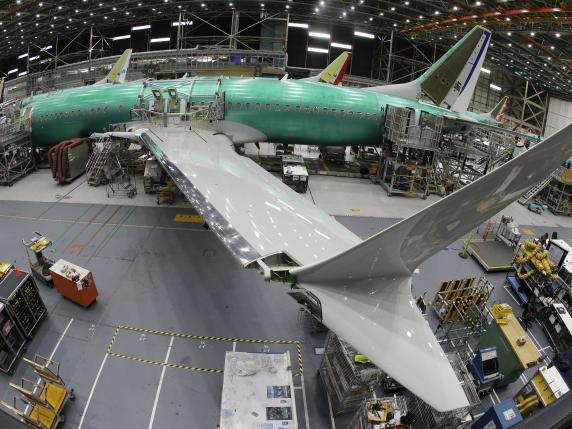 FILE - In this photo taken with a fish-eye lens, a Boeing 737 MAX 8 airplane sits on the assembly line during a brief media tour in Boeing's 737 assembly facility in Renton, Wash., March 27, 2019. Boeing is in talks to buy Spirit AeroSystems, which builds fuselages for Boeing 737 Max jetliners including the one that suffered a door-panel blowout in January, according to a published report, Friday, March 1, 2024. (AP Photo/Ted S. Warren, File)