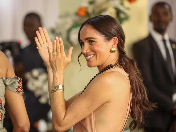 Britain's Meghan, Duchess of Sussex, gestures as she arrives with Britain's Prince Harry (unseen), Duke of Sussex, during their visit at the Lightway Academy in Abuja on May 10, 2024 as they visit Nigeria as part of celebrations of Invictus Games anniversary. (Photo by Kola SULAIMON / AFP)