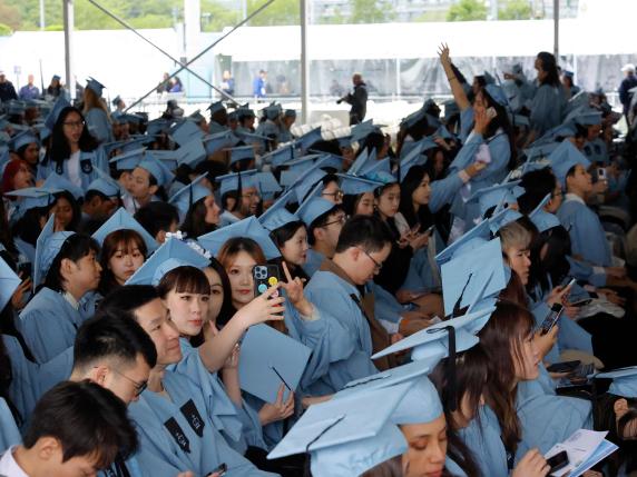 NEW YORK, NEW YORK - MAY 10: Students from the Columbia School of Professional Studies await the start of their graduation ceremony at the Baker Athletics Complex on May 10, 2024 in New York City. Columbia University is holding several smaller commencement ceremonies for its students after cancelling their main ceremony on the South Lawn of the Morningside Heights campus after several weeks of protest with students setting up an encampment in solidarity with Palestinians in Gaza.   Michael M. Santiago/Getty Images/AFP (Photo by Michael M. Santiago / GETTY IMAGES NORTH AMERICA / Getty Images via AFP)