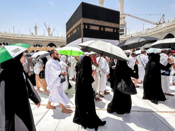 (FILES) Muslim devotees walk around the Kaaba, Islam's holiest shrine, at the Grand Mosque in Saudi Arabia's holy city of Mecca on June 13, 2024, ahead of the annual Hajj pilgrimage. Friends and family searched for missing hajj pilgrims on June 19 as the death toll at the annual rituals, which were carried out in scorching heat, surged past 900. (Photo by FADEL SENNA / AFP)