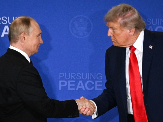 (FILES) US President Donald Trump (R) and Russian President Vladimir Putin shake hands at the end of a joint press conference after participating in a US-Russia summit on Ukraine at Joint Base Elmendorf-Richardson in Anchorage, Alaska, on August 1...