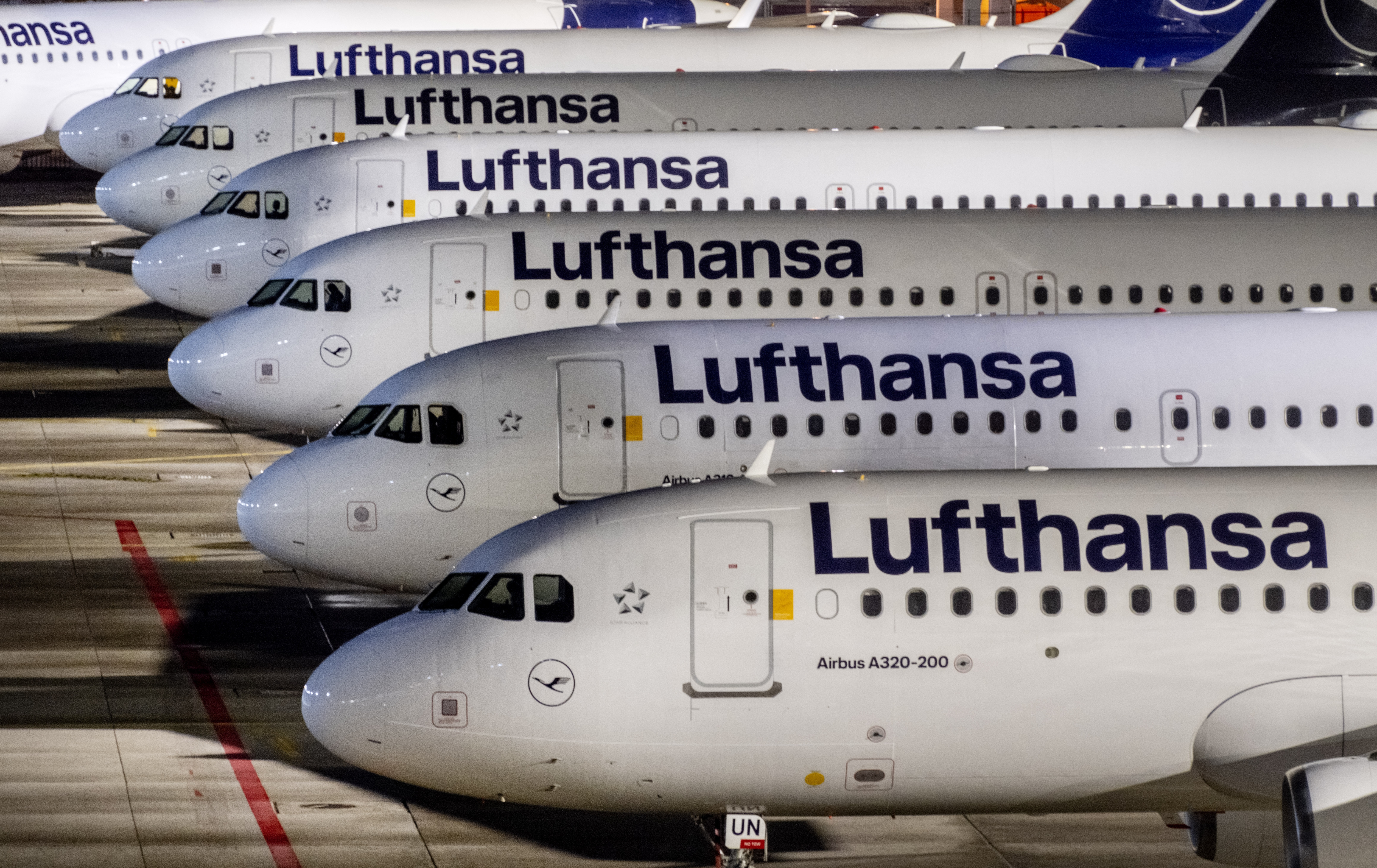 Lufthansa aircrafts are parked at the airport in Frankfurt, Germany, Wednesday, Feb. 7, 2024. The ground staff of German Lufthansa airline went for a one-day warning strike on Wednesday causing the cancellation of hundreds of flights. (AP Photo/Michael Probst)