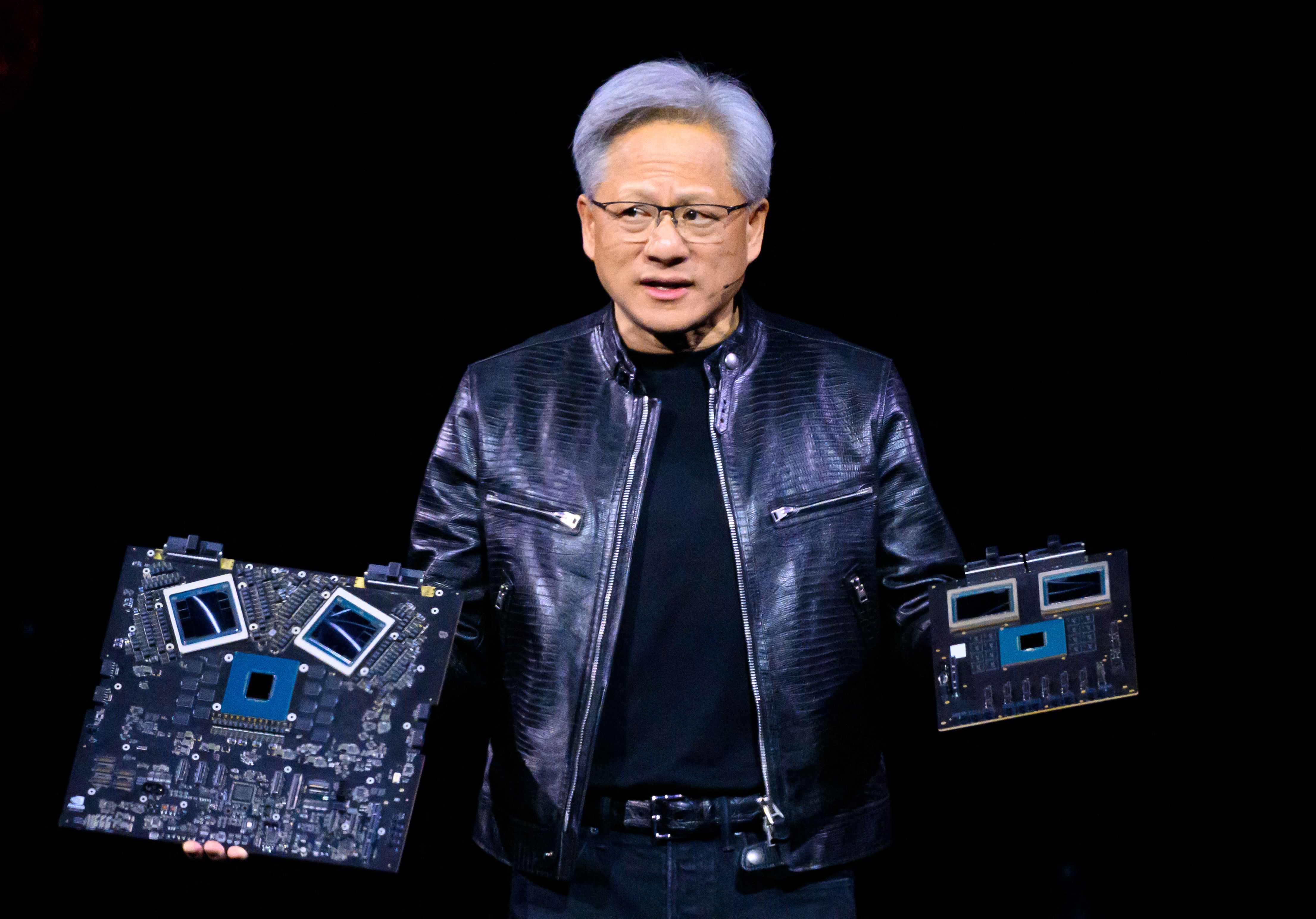 NVIDIA's CEO Jensen Huang displays products on-stage during the annual Nvidia GTC Artificial Intelligence Conference at SAP Center in San Jose, California, on March 18, 2024. (Photo by JOSH EDELSON / AFP)