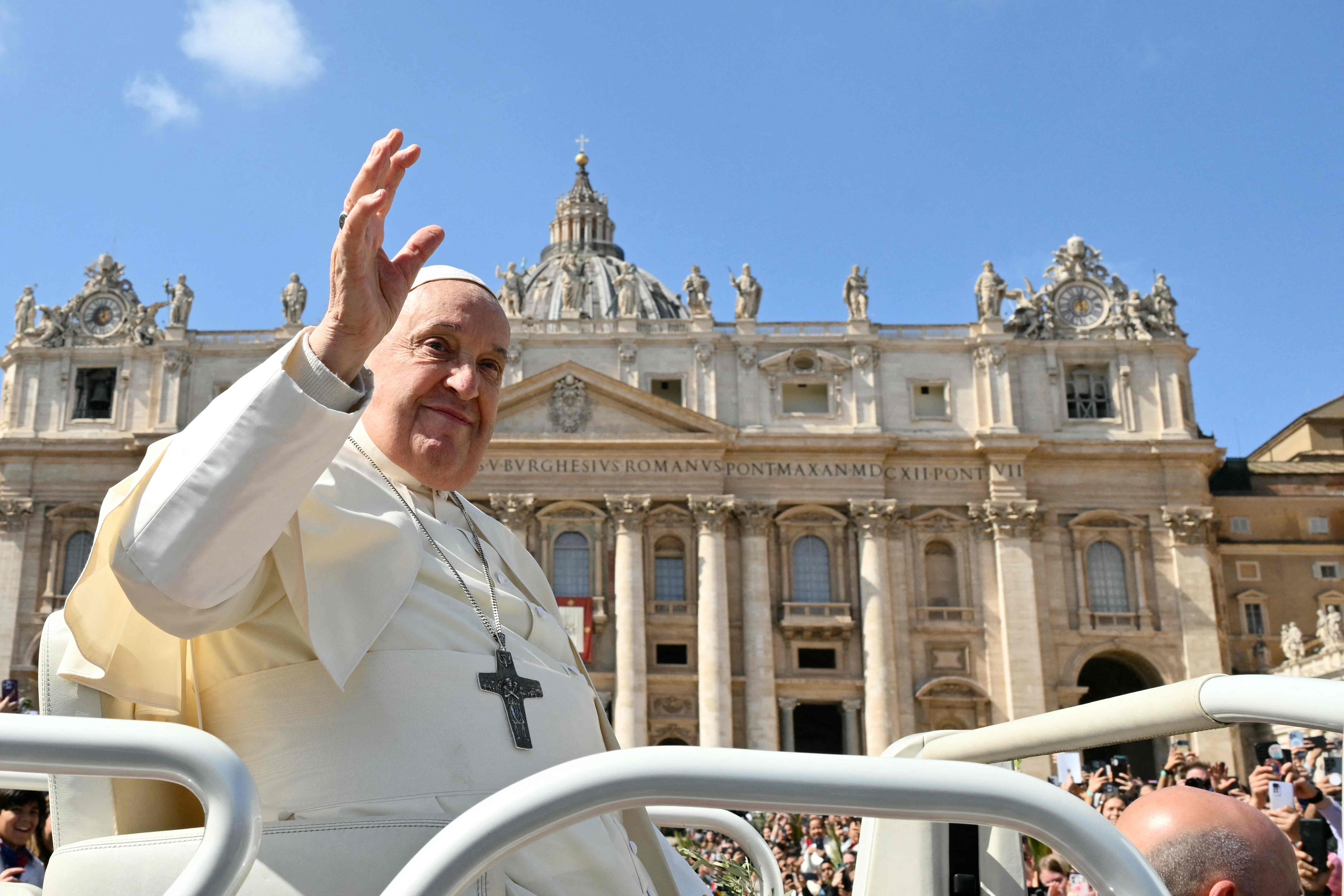 Pope Francis greets the crowd from the popemobile at the end of the Palm Sunday mass at St Peter's square in the Vatican on March 24, 2024. (Photo by Alberto PIZZOLI / AFP)