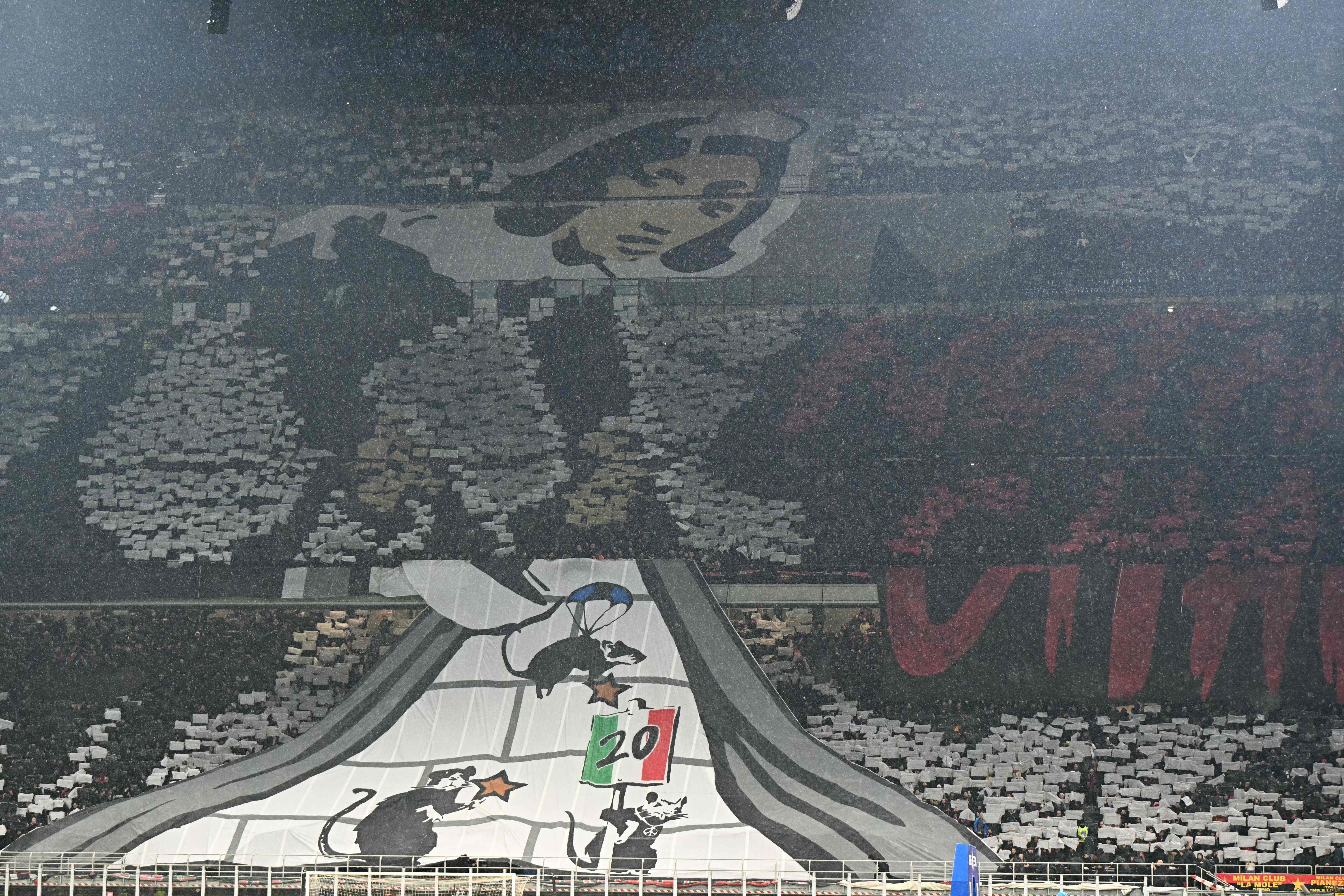 Ultras supporters of AC Milan hold banners prior to the Italian Serie A football match between AC Milan and Inter Milan at the San Siro Stadium in Milan on April 22, 2024. (Photo by GABRIEL BOUYS / AFP)
