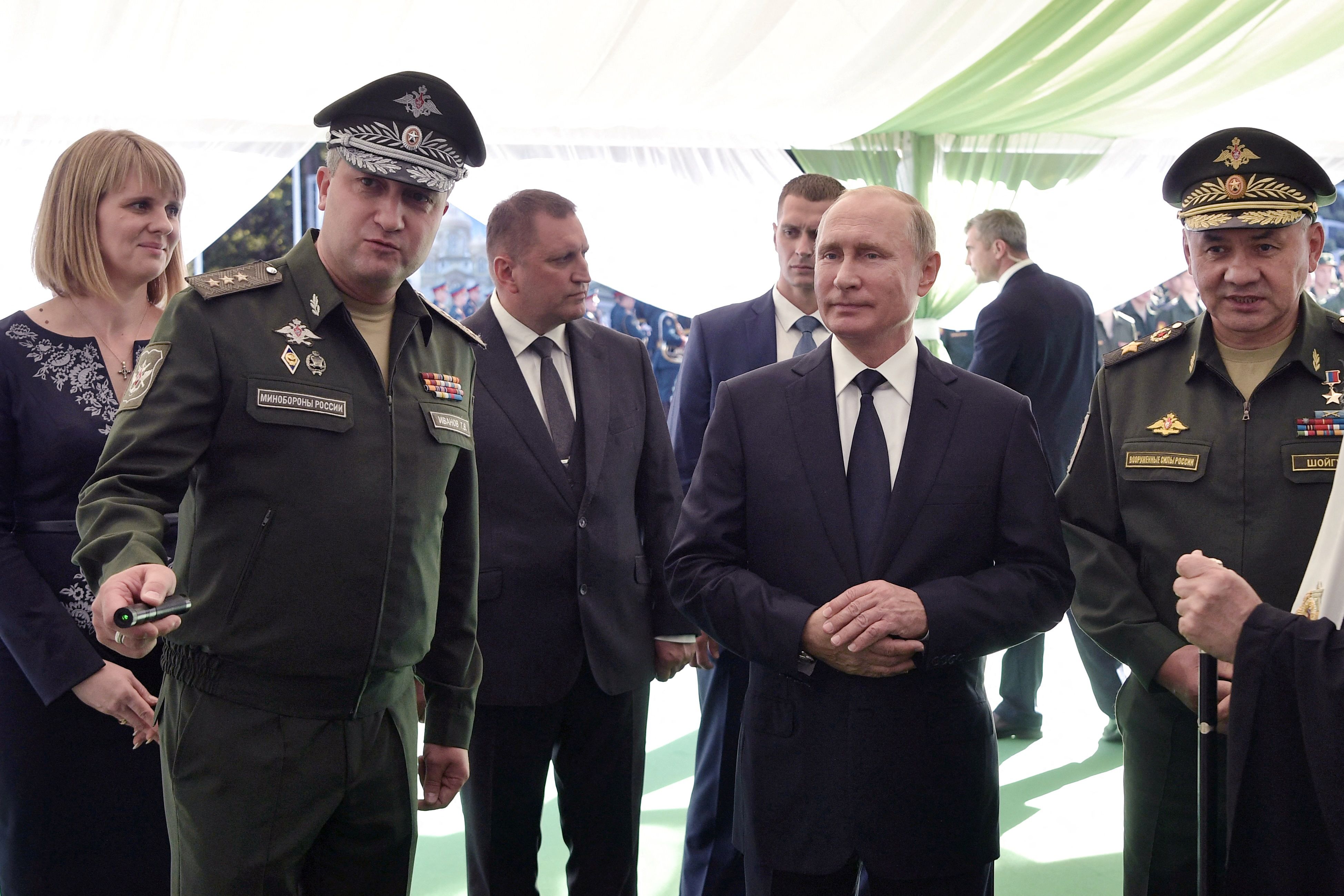 In this pool photograph distributed by Russian state owned agency Sputnik, Russia's President Vladimir Putin (C), Russian Defence Minister Sergei Shoigu (R) and Deputy Minister of Defense of the Russian Federation Timur Ivanov (L) visit the military Patriot Park in Kubinka, outside Moscow, on September 19, 2018. Russian law enforcement have detained Deputy Defence Minister Timur Ivanov on suspicion of taking bribes, Russia's Investigative Committee said on April 23, 2024. (Photo by Alexey NIKOLSKIY / POOL / AFP) / ** Editor's note : this image is distributed by Russian state owned agency Sputnik **
