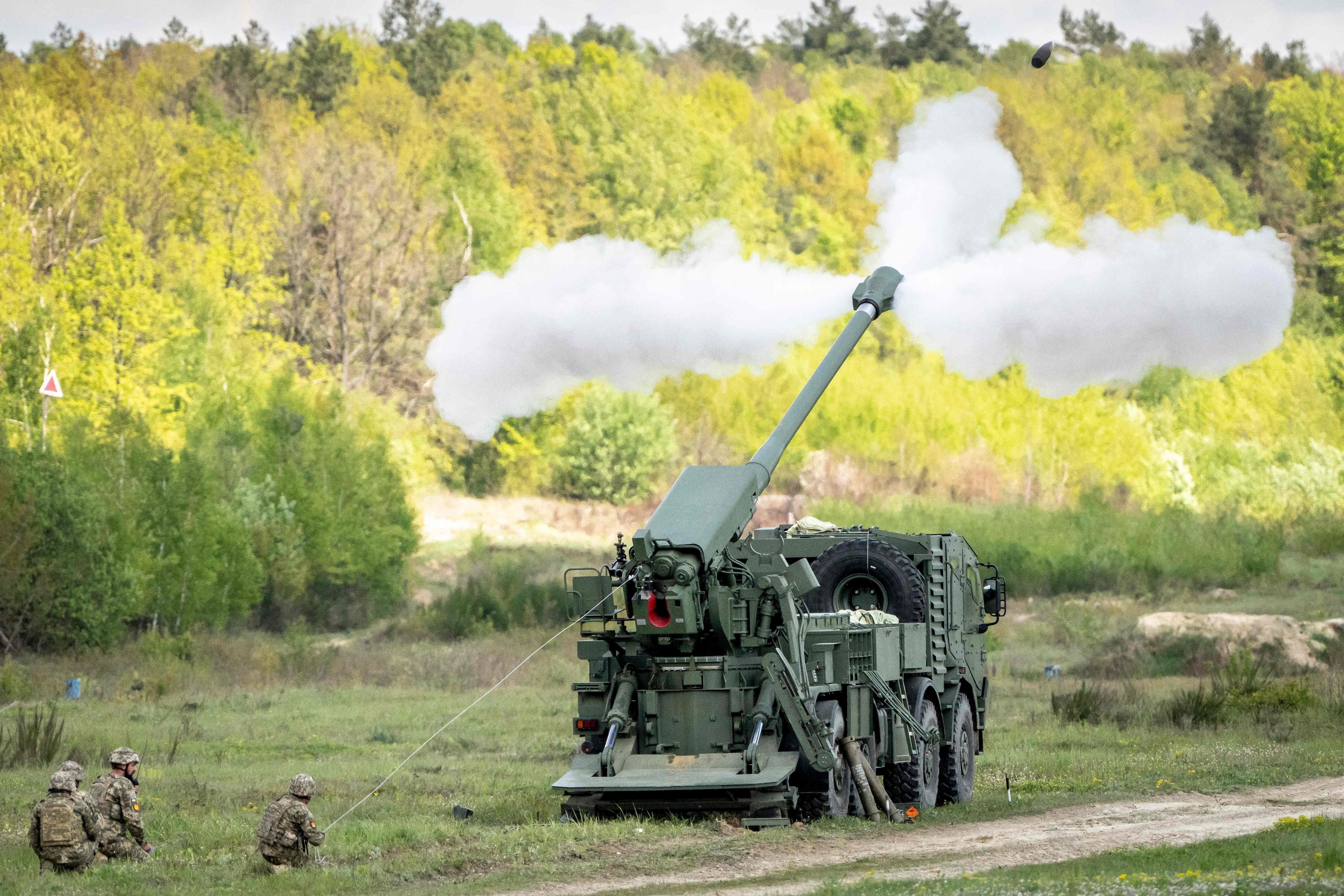 Soldiers trigger a Bohdana artillery system, which is produced in Ukraine, winessed by Denmark's Foreign Minister and Defence Minister (not in picture) as part of his visit to Lviv on April 27, 2024. Denmark's government said on April 25, 2024 it was adding 4.4 billion kroner ($630 million) for military aid to its Ukraine aid fund as Kyiv pleads Western allies for more support against Russia's invasion. (Photo by Mads Claus Rasmussen / Ritzau Scanpix / AFP) / Denmark OUT