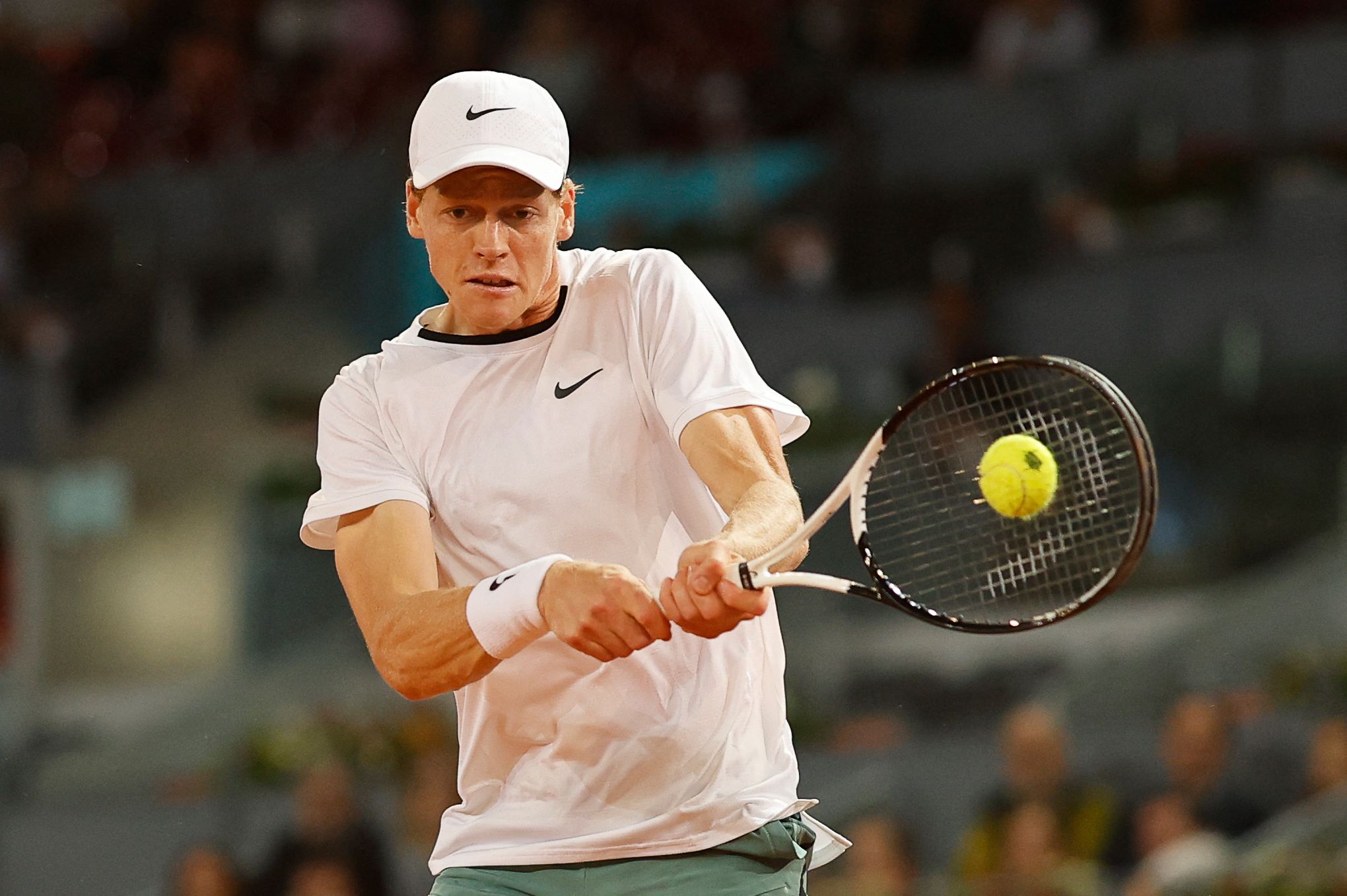 Italy's Jannik Sinner returns the ball to Russia's Pavel Kotov during the third round of the 2024 ATP Tour Madrid Open tournament tennis match at Caja Magica in Madrid on April 29, 2024. (Photo by OSCAR DEL POZO / AFP)